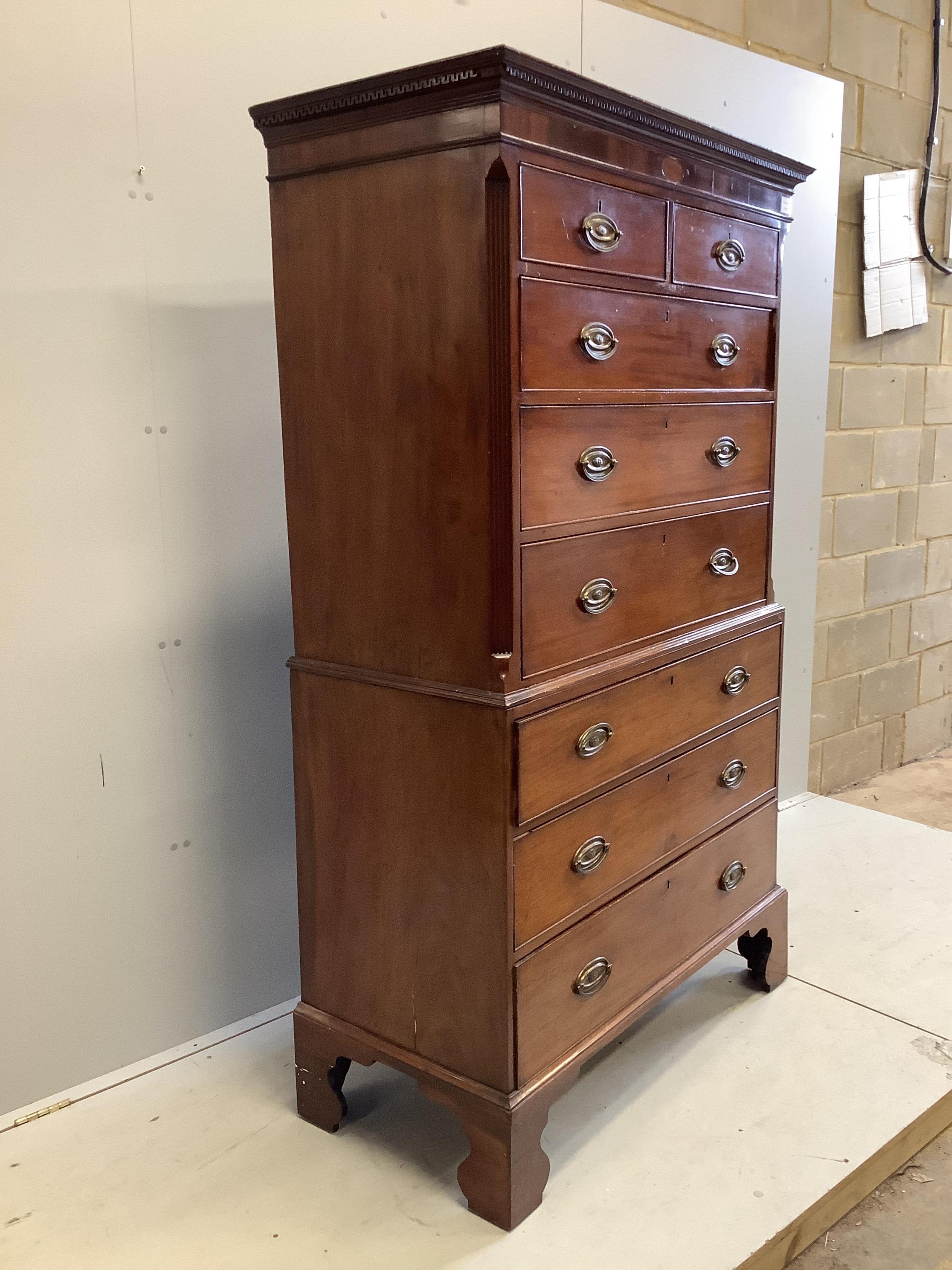 A George III inlaid mahogany chest on chest, width 106cm, depth 50cm, height 185cm. Condition - fair